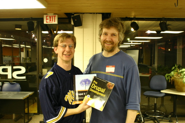 Mike Hofmockel presented Eric J. Klooster, a representative of the Ann Arbor Public Library, two books that a2Drupal donated at our 1 year anniversary celebration